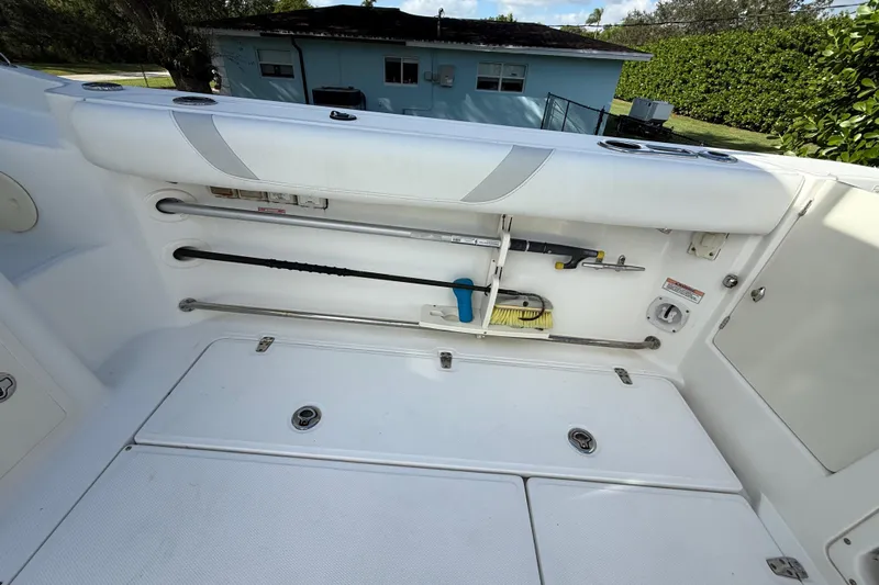  Yacht Photos Pics 2011 Boston Whaler 285 Conquest boat deck with storage compartments and tools.