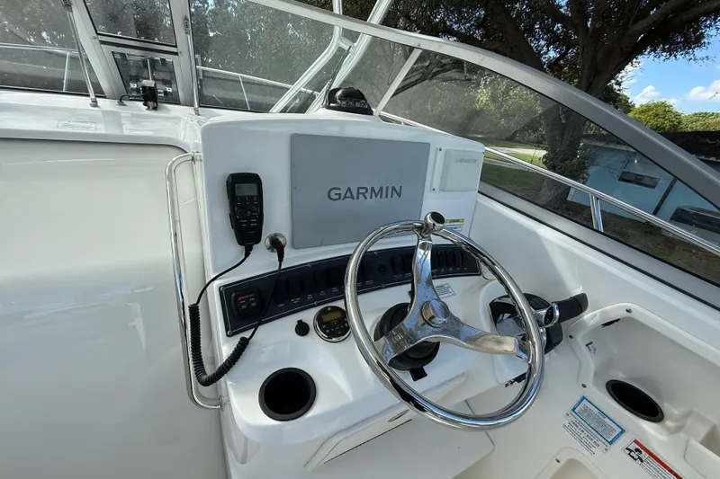  Yacht Photos Pics 2011 Boston Whaler 285 Conquest helm with Garmin navigation system and steering wheel.
