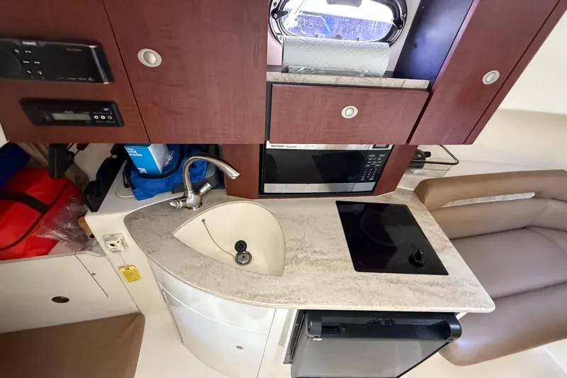  Yacht Photos Pics 2011 Boston Whaler 285 Conquest interior kitchen with sink, stove, and microwave.