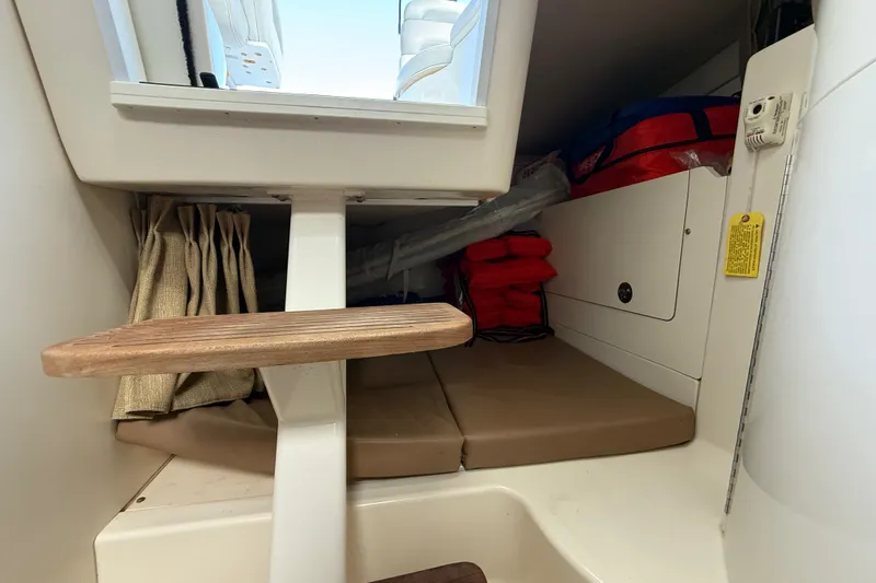  Yacht Photos Pics 2011 Boston Whaler 285 Conquest cabin interior with storage and life jackets.