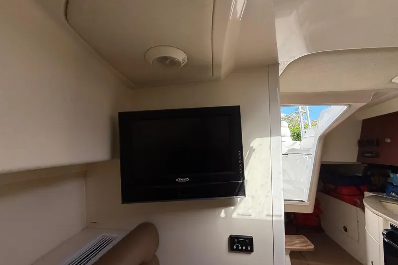  Yacht Photos Pics Interior of 2011 Boston Whaler 285 Conquest with wall-mounted TV and cabin view.