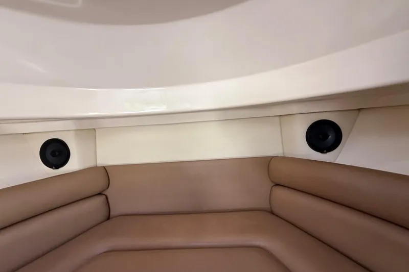  Yacht Photos Pics Interior of 2011 Boston Whaler 285 Conquest with cushioned seating and built-in speakers.