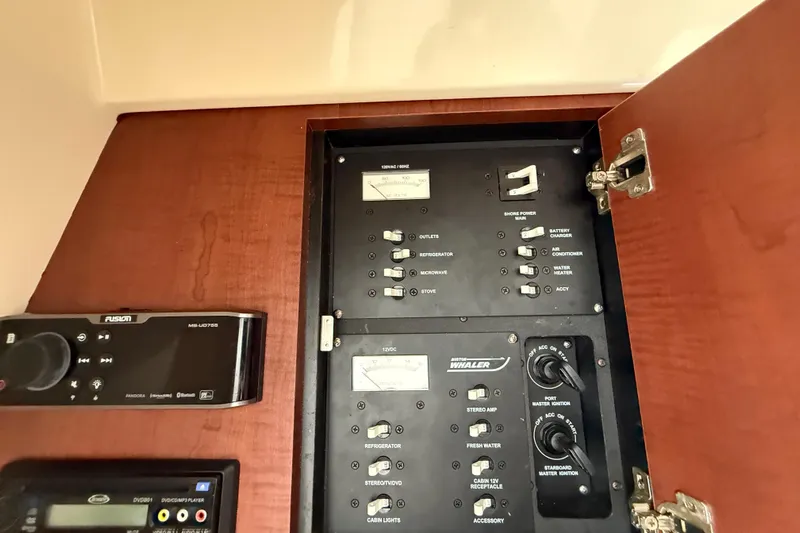  Yacht Photos Pics Electrical control panel on 2011 Boston Whaler 285 Conquest boat, featuring various switches and gauges.