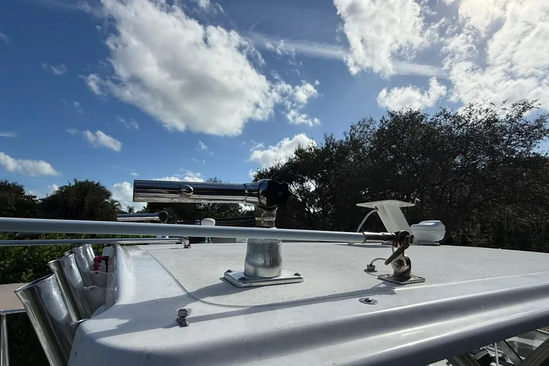  Yacht Photos Pics 2011 Boston Whaler 285 Conquest boat deck with clear sky and trees in background.