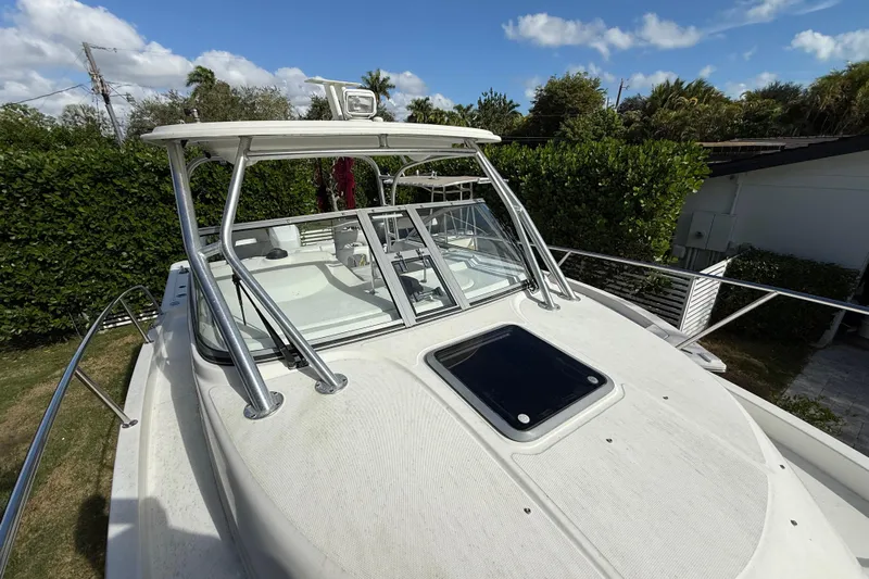  Yacht Photos Pics 2011 Boston Whaler 285 Conquest boat with hardtop and windshield, docked outdoors.