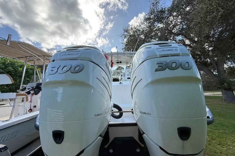  Yacht Photos Pics 2011 Boston Whaler 285 Conquest with twin 300 Verado engines, parked outdoors.