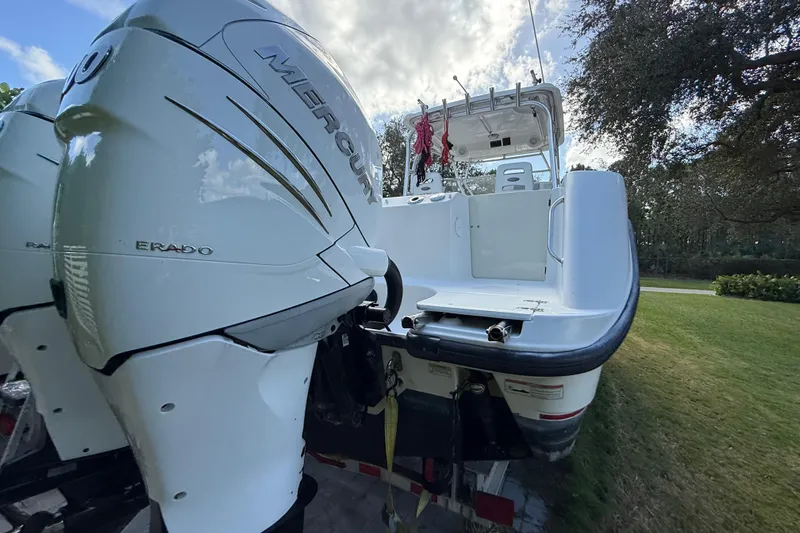  Yacht Photos Pics 2011 Boston Whaler 285 Conquest boat with dual Mercury engines, parked on grass.