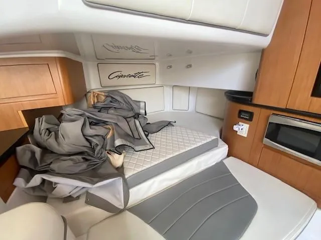 Cigarette 42 Yacht Photos Pics Interior cabin of a 2017 Cigarette 42 Huntress boat with bedding and wood cabinetry.