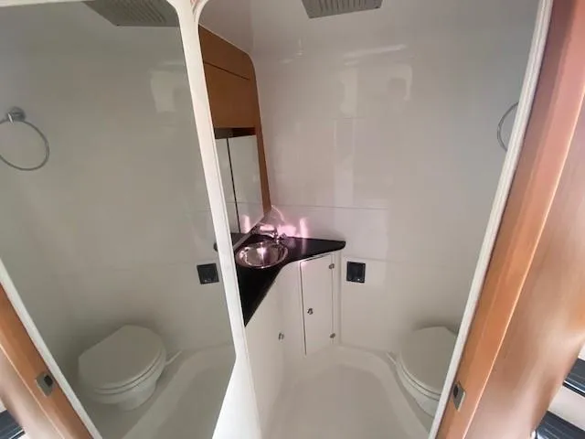 Cigarette 42 Yacht Photos Pics 2017 Cigarette 42 Huntress bathroom with sink, mirror, and toilet in compact design.