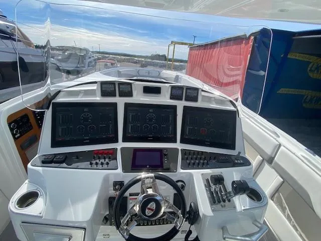 Cigarette 42 Yacht Photos Pics Control panel of a 2017 Cigarette 42 Huntress boat with multiple screens and controls.