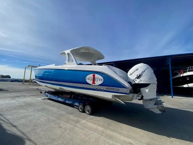 Cigarette 42 Yacht Photos Pics 2017 Cigarette 42 Huntress boat on trailer, blue and white design, parked outdoors.