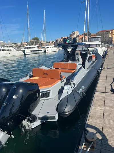 Yacht Photos Pics 2025 DNA 46 boat docked in a marina with other yachts.