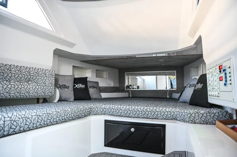  Yacht Photos Pics Modern DNA 46 boat interior, 2025 model, featuring a spacious cabin with patterned cushions and control panel.