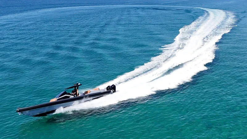  Yacht Photos Pics High-speed DNA 46 boat cruising on clear blue ocean waters, 2025 model.