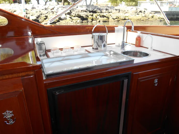 Dazzler Yacht Photos Pics 1969 Lyman Sportsman boat interior with wooden cabinetry and compact kitchenette.
