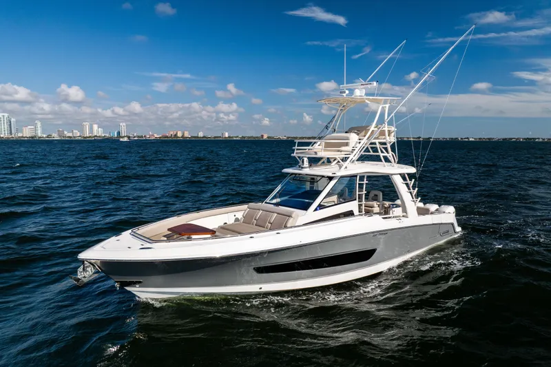 Smoke Show Yacht Photos Pics 2021 Boston Whaler 420 Outrage cruising on open water under clear blue skies.