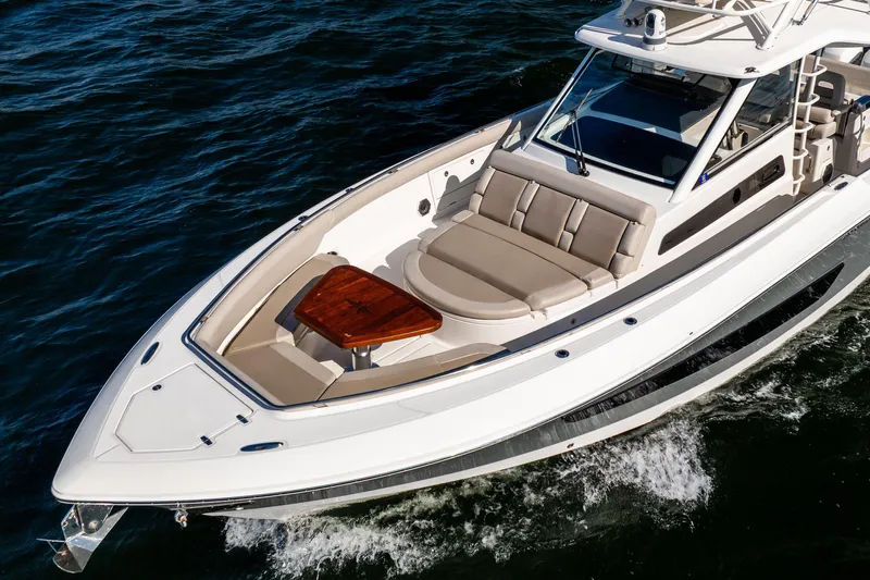 Smoke Show Yacht Photos Pics 2021 Boston Whaler 420 Outrage cruising on water, showcasing luxury seating and sleek design.