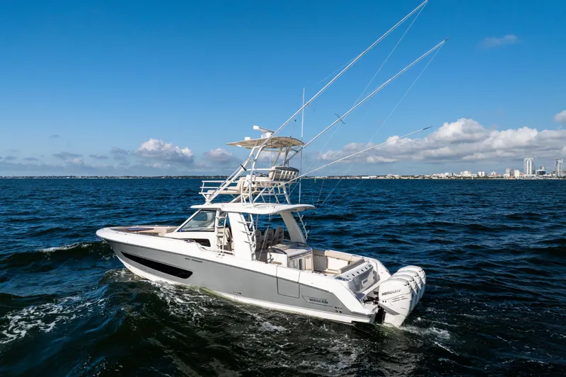 Smoke Show Yacht Photos Pics 2021 Boston Whaler 420 Outrage cruising on open water under a clear blue sky.