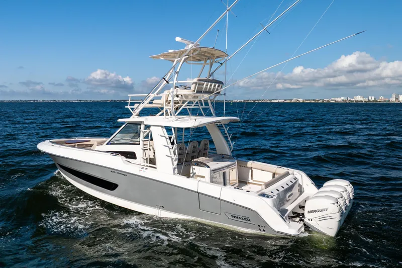 Smoke Show Yacht Photos Pics 2021 Boston Whaler 420 Outrage boat cruising on open water, clear sky background.