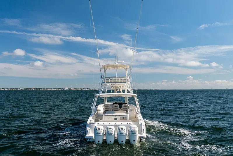 Smoke Show Yacht Photos Pics 2021 Boston Whaler 420 Outrage cruising on open water under a clear blue sky.