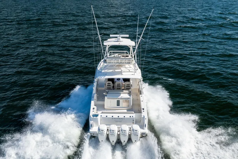 Smoke Show Yacht Photos Pics 2021 Boston Whaler 420 Outrage cruising on open water, rear view.