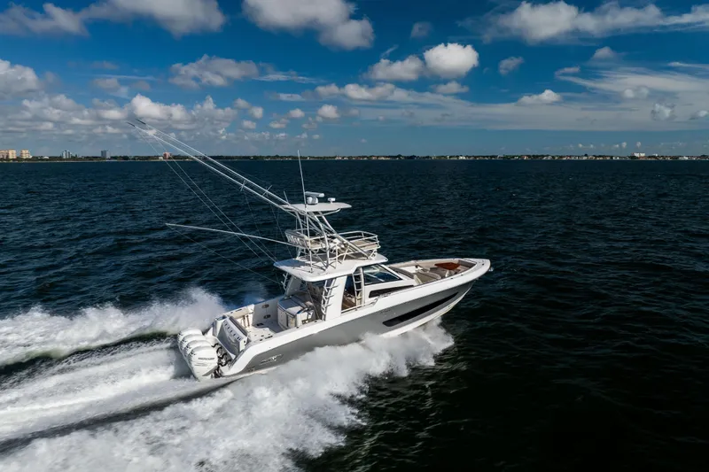 Smoke Show Yacht Photos Pics 2021 Boston Whaler 420 Outrage cruising on open water under a blue sky.