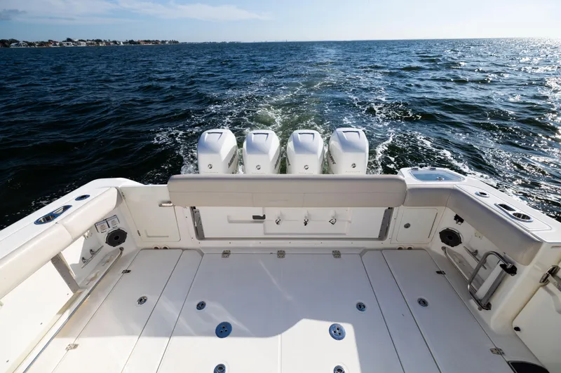 Smoke Show Yacht Photos Pics 2021 Boston Whaler 420 Outrage boat deck with quad engines on open water.
