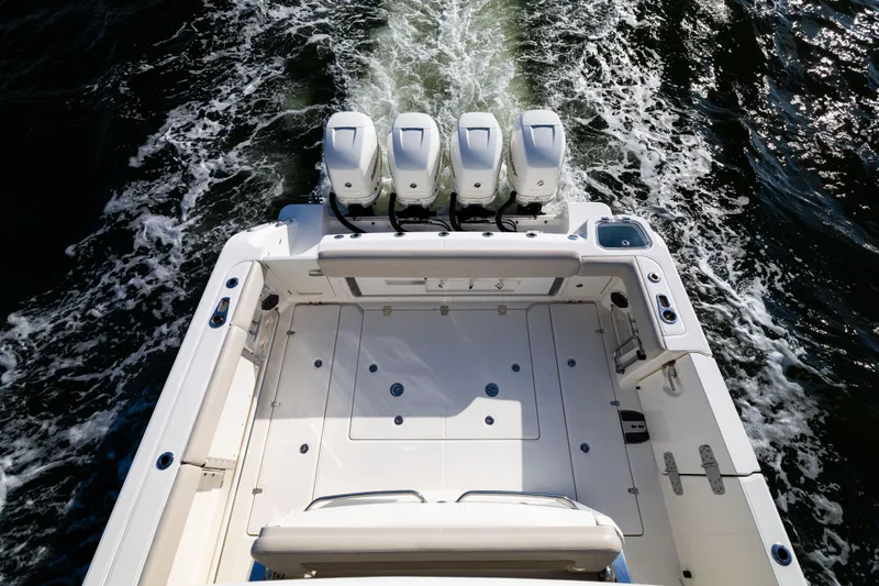 Smoke Show Yacht Photos Pics 2021 Boston Whaler 420 Outrage boat with four engines cruising on water.