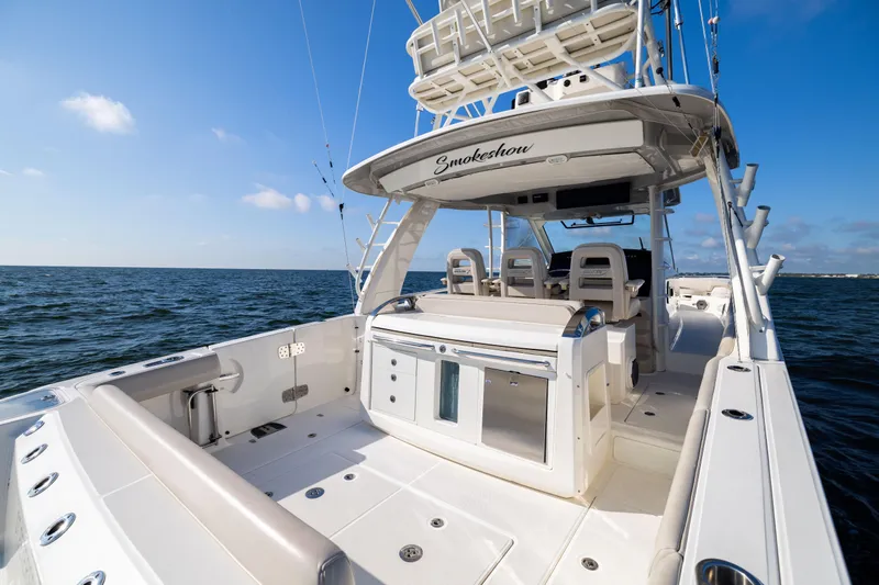 Smoke Show Yacht Photos Pics 2021 Boston Whaler 420 Outrage boat on open water, featuring spacious deck and seating.