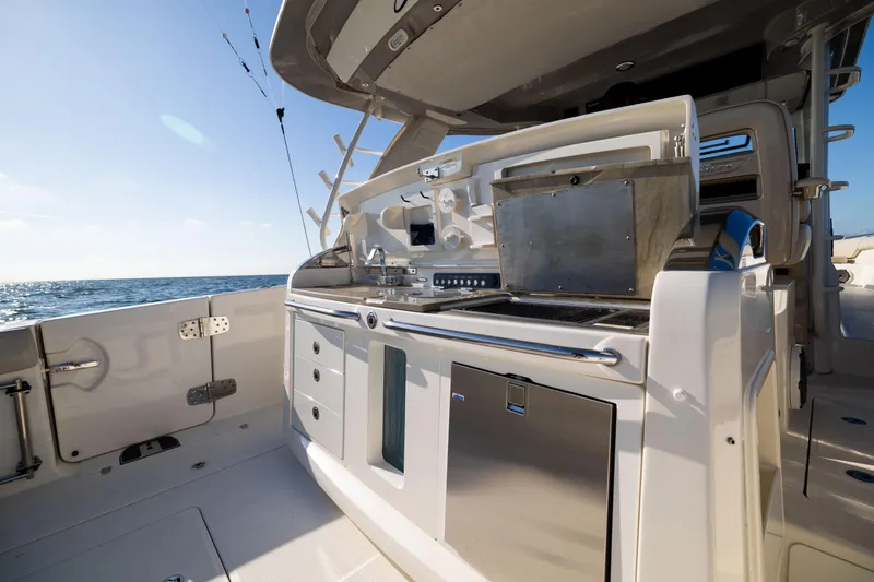 Smoke Show Yacht Photos Pics 2021 Boston Whaler 420 Outrage boat kitchen area with ocean view.