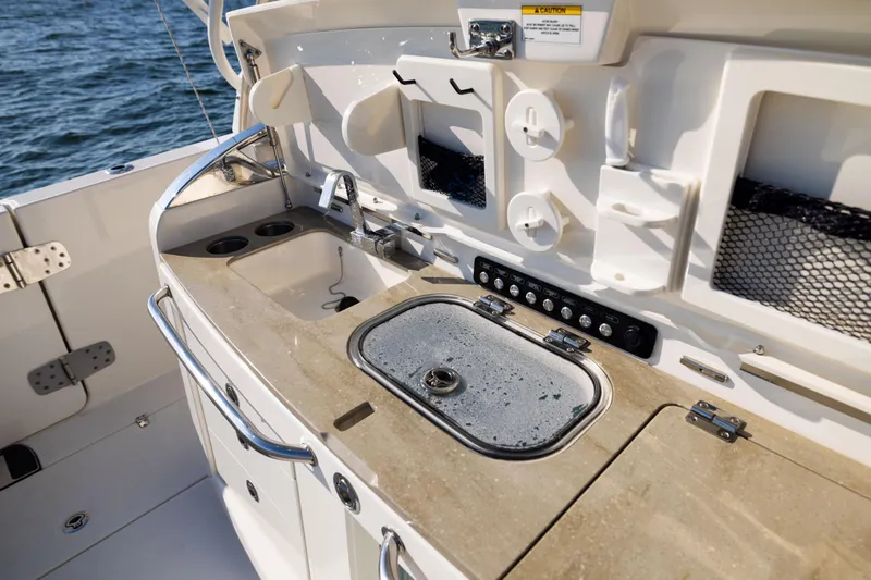 Smoke Show Yacht Photos Pics Boston Whaler 420 Outrage 2021 boat galley with sink and storage, on open water.