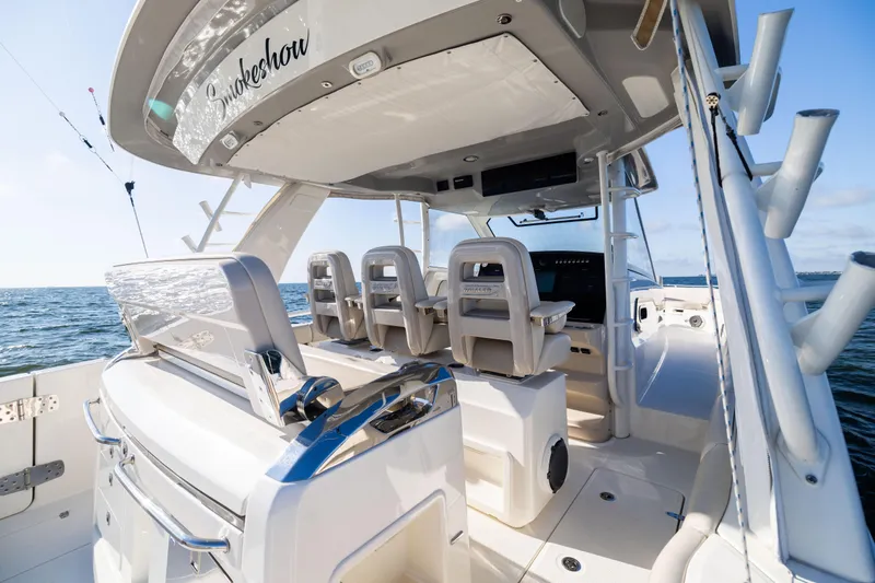 Smoke Show Yacht Photos Pics 2021 Boston Whaler 420 Outrage boat interior, featuring luxurious seating and ocean view.