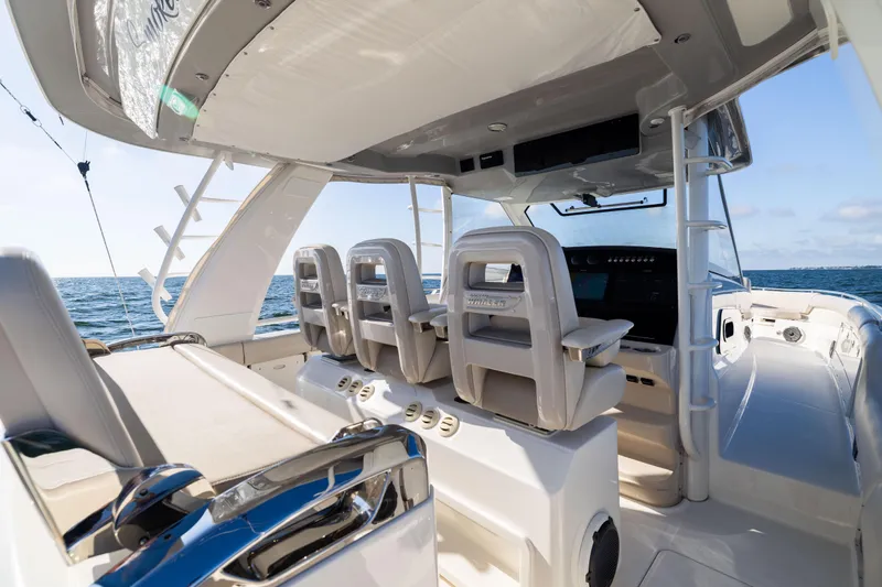 Smoke Show Yacht Photos Pics 2021 Boston Whaler 420 Outrage helm with luxurious seating and ocean view.