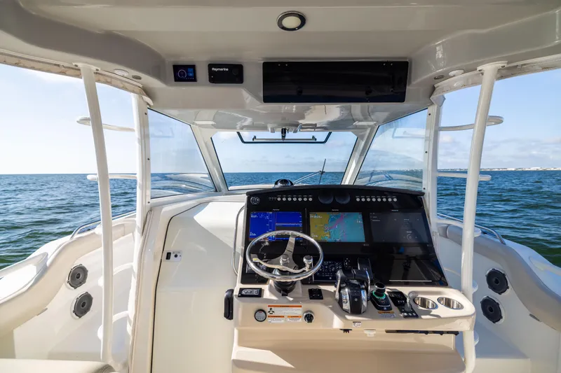 Smoke Show Yacht Photos Pics 2021 Boston Whaler 420 Outrage helm with advanced navigation system on open water.