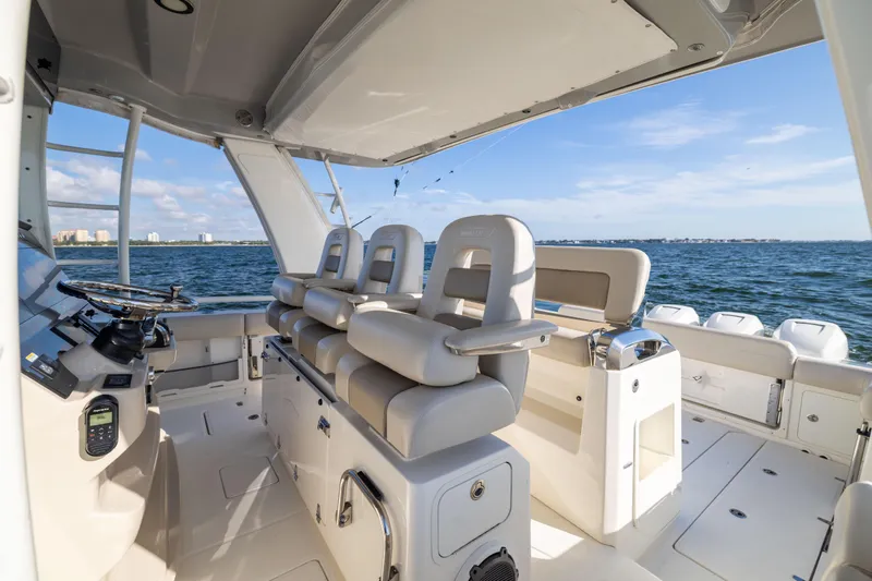Smoke Show Yacht Photos Pics 2021 Boston Whaler 420 Outrage boat interior with helm and seating, ocean view.