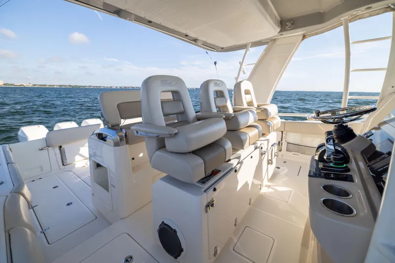 Smoke Show Yacht Photos Pics 2021 Boston Whaler 420 Outrage boat interior with luxurious seating and ocean view.
