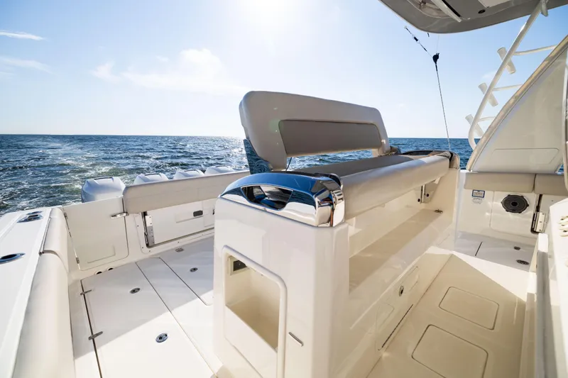 Smoke Show Yacht Photos Pics 2021 Boston Whaler 420 Outrage boat interior with ocean view, showcasing luxury seating.
