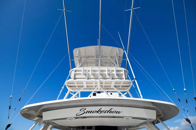 Smoke Show Yacht Photos Pics Boston Whaler 420 Outrage 2021 boat with fishing rods against clear blue sky.