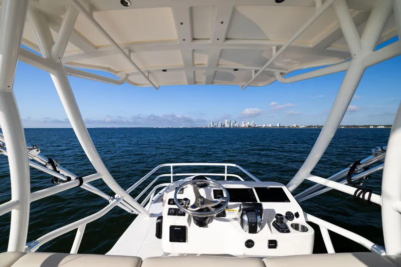 Smoke Show Yacht Photos Pics Boston Whaler 420 Outrage 2021 helm view with city skyline in the distance.
