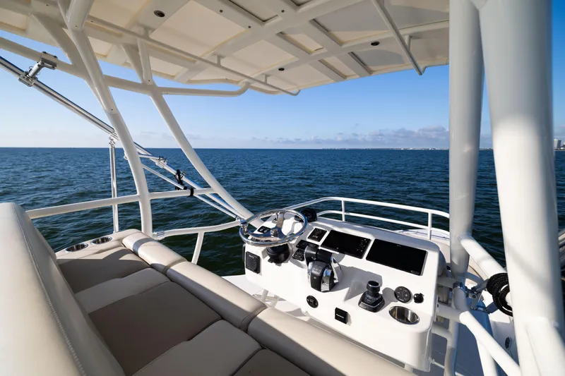 Smoke Show Yacht Photos Pics 2021 Boston Whaler 420 Outrage helm with ocean view, showcasing luxury and advanced navigation features.