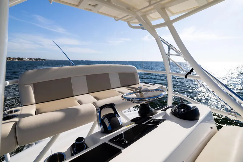 Smoke Show Yacht Photos Pics 2021 Boston Whaler 420 Outrage helm with ocean view, featuring modern controls and seating.
