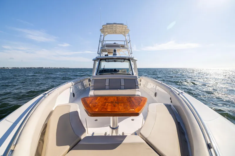 Smoke Show Yacht Photos Pics 2021 Boston Whaler 420 Outrage cruising on open water, featuring spacious deck and seating.