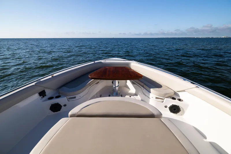 Smoke Show Yacht Photos Pics 2021 Boston Whaler 420 Outrage boat interior with ocean view, featuring seating and table.