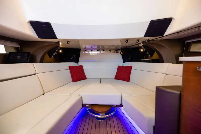 Smoke Show Yacht Photos Pics Luxurious interior of 2021 Boston Whaler 420 Outrage with white seating and red cushions.