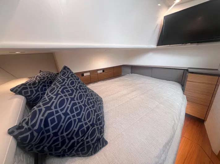  Yacht Photos Pics 2023 Tiara Yachts 38 LS cabin interior with bed, pillows, and TV.