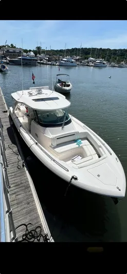  Yacht Photos Pics 2023 Tiara Yachts 38 LS docked in a marina, showcasing sleek design and luxury features.