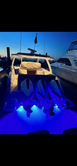  Yacht Photos Pics 2023 Tiara Yachts 38 LS with illuminated blue underwater lights at dusk.