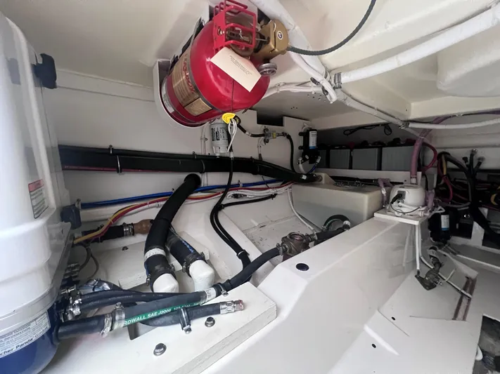  Yacht Photos Pics Engine compartment of 2023 Tiara Yachts 38 LS, featuring fire extinguisher and various mechanical components.