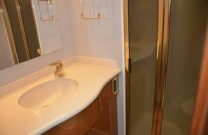 Tomaso 5 Yacht Photos Pics Bathroom interior of 2004 Viking 52 Convertible yacht with sink and shower.