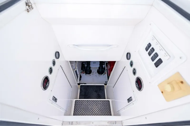 Tomaso 5 Yacht Photos Pics Engine room access of 2004 Viking 52 Convertible yacht, featuring control panels and gauges.